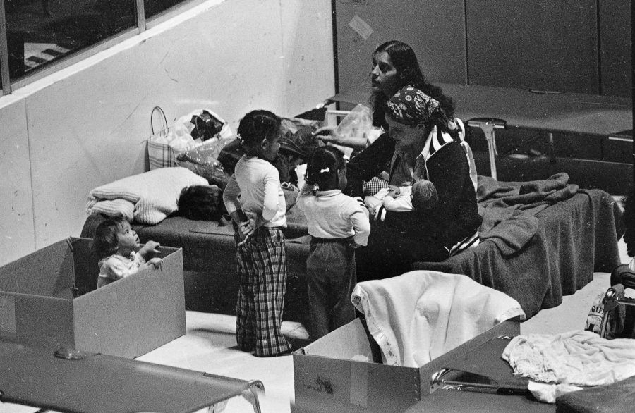 Women and children who have been evacuated sleep on army cots at a sports arena on March 31, 1979.
