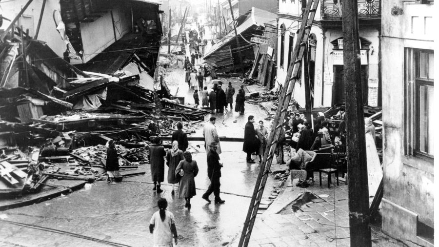 Residents of Valdivia, Chile, look over wrecked buildings on May 31, 1960. /AP NPR 2023
