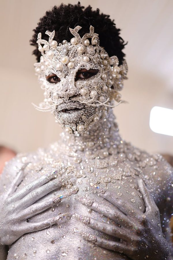 Photo by POPSUGAR: 
Lil Nas X covered in silver paint and rhinestones. 