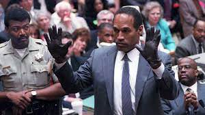 O.J. Simpson putting on the leather glove.
